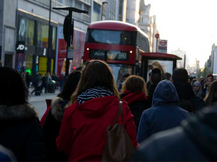 Passengers await the arrival of the 390 service