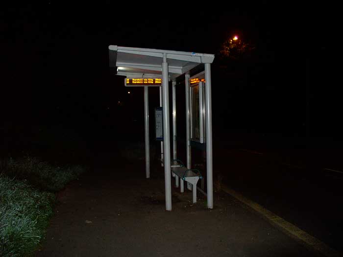 A bus shelter with a display screen